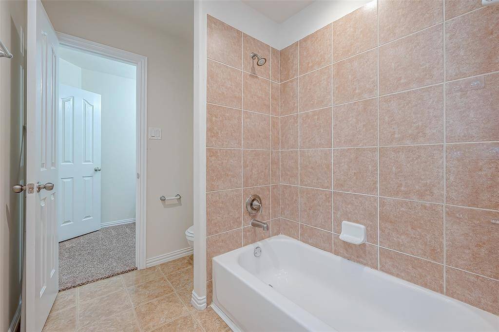 Secondary bath with shower tub combo.