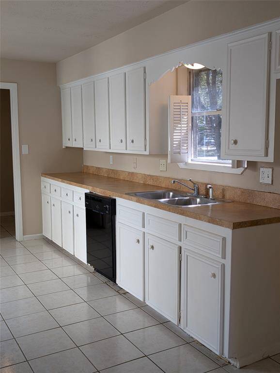 Window over the sink is a great idea. Dishwasher looks like new on the outside.
