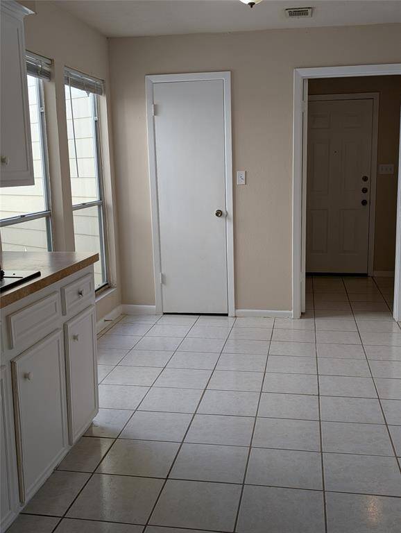 Breakfast area is flooded with light and looks out into the atrium.  Laundry area and garage is to your right.  Pantry in foreground.