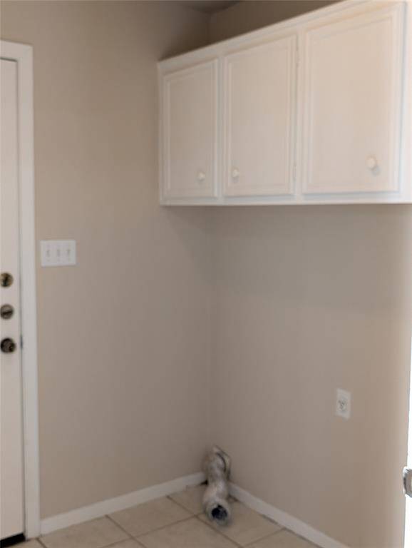 Laundry room with additional storage leads out to the garage.