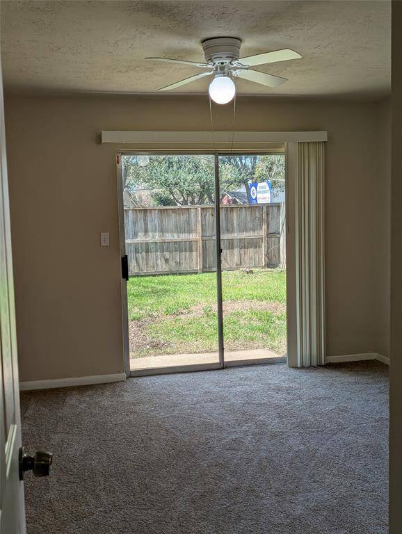 Moving into the bedroom areas, the carpeting is in good condition.  Sliding glass patio door is in this primary bedroom.