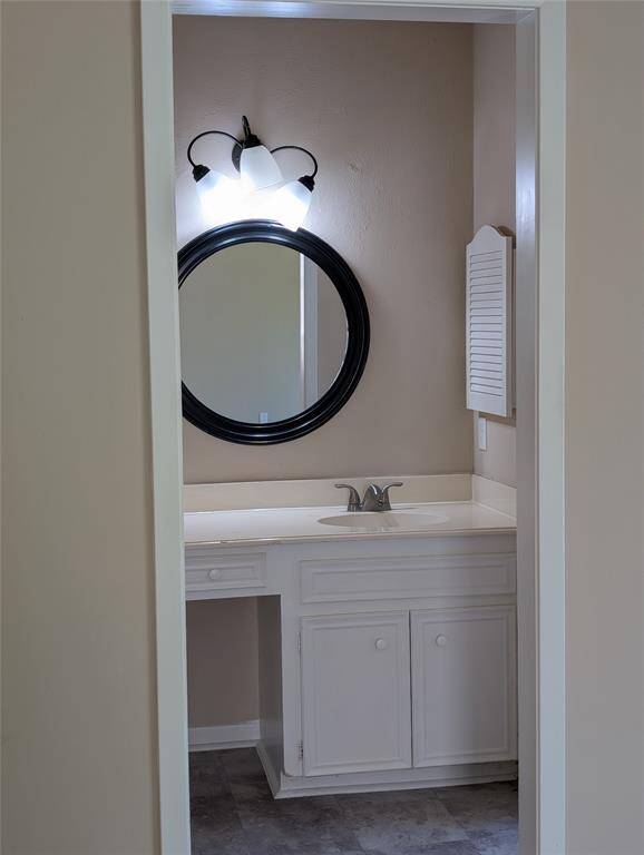 Primary bath vanity area has a sit down makeup area and a built in medicine cabinet.