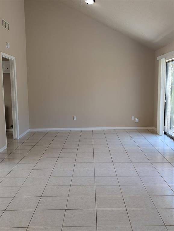 Tall ceilings in this area give the appearance of it being a much larger space. Kitchen to the left.