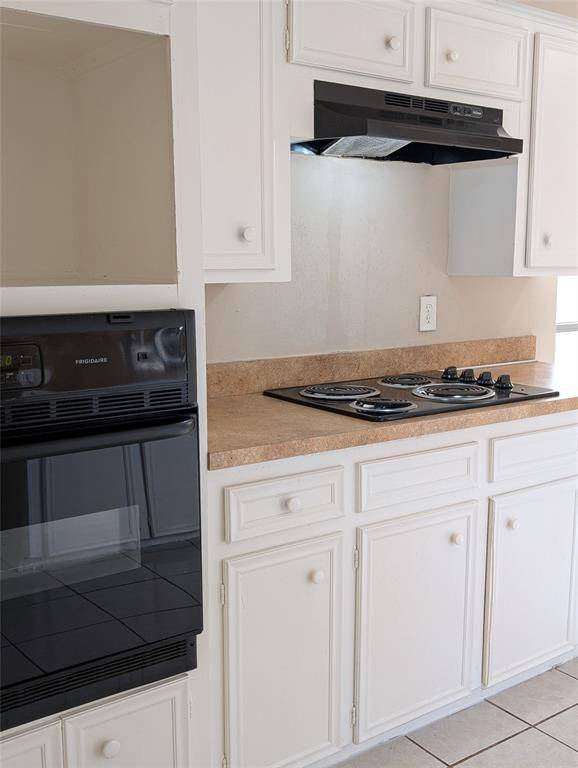 Kitchen size is great.  So many cabinets! Formica counters, tiled floors.  There's a cabinet above the oven showing a spot to put a microwave - OR chang this out to include a double oven?