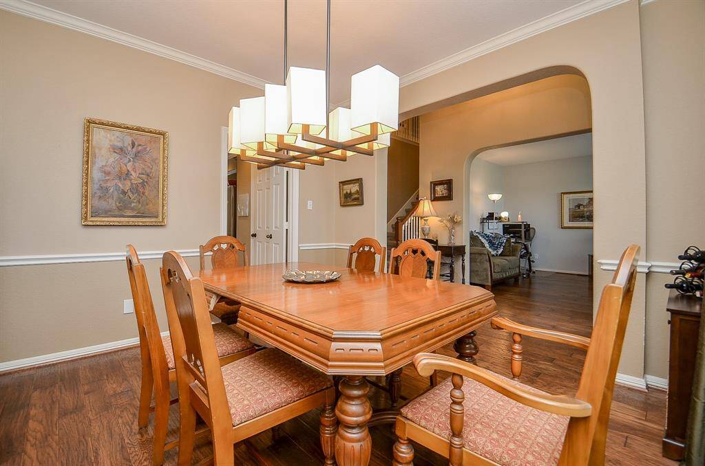 Formal Dining Room has chair and crown molding.