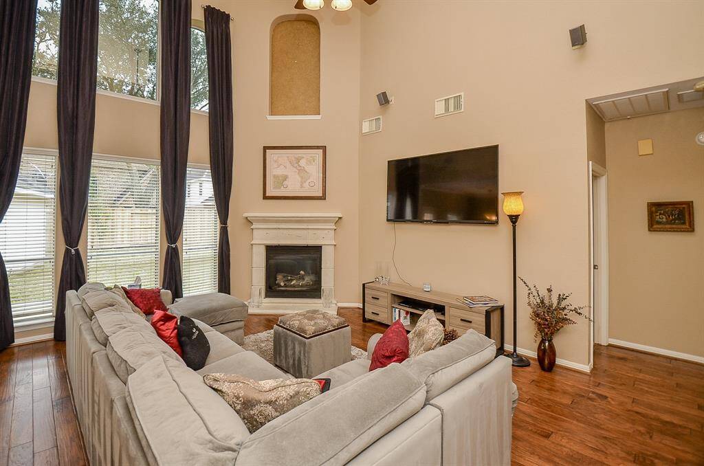 Large Family Room with a Fireplace and Hardwood Flooring!