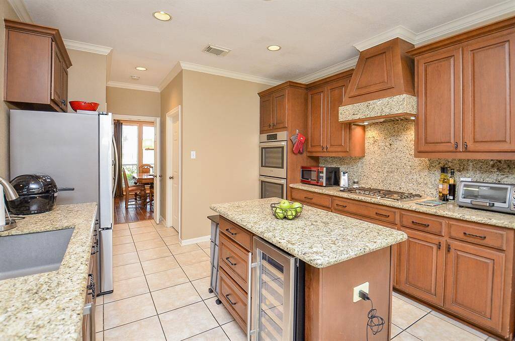 Large Island Kitchen with a wine refrigerator is truly a culinary dream!