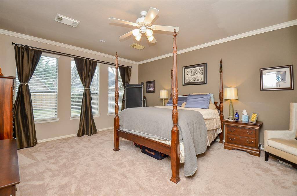Primary Bedroom is Large with crown molding and a wall of windows!
