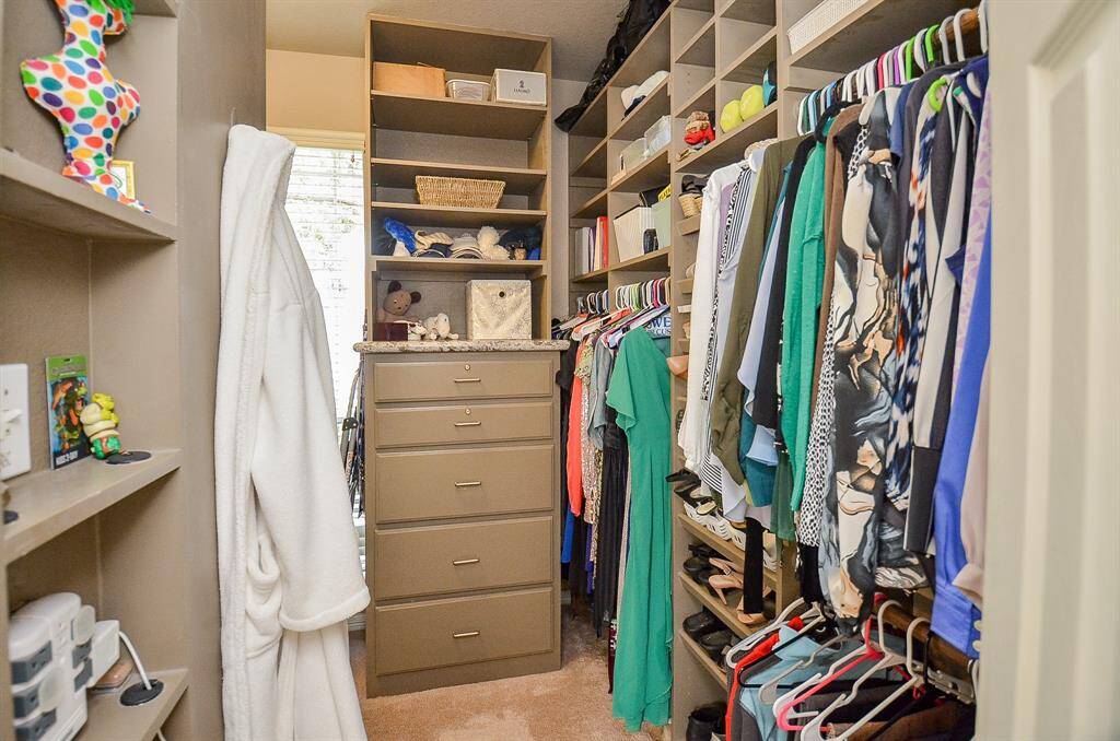 another view of the primary closet showing off the upgraded custom build-out.
