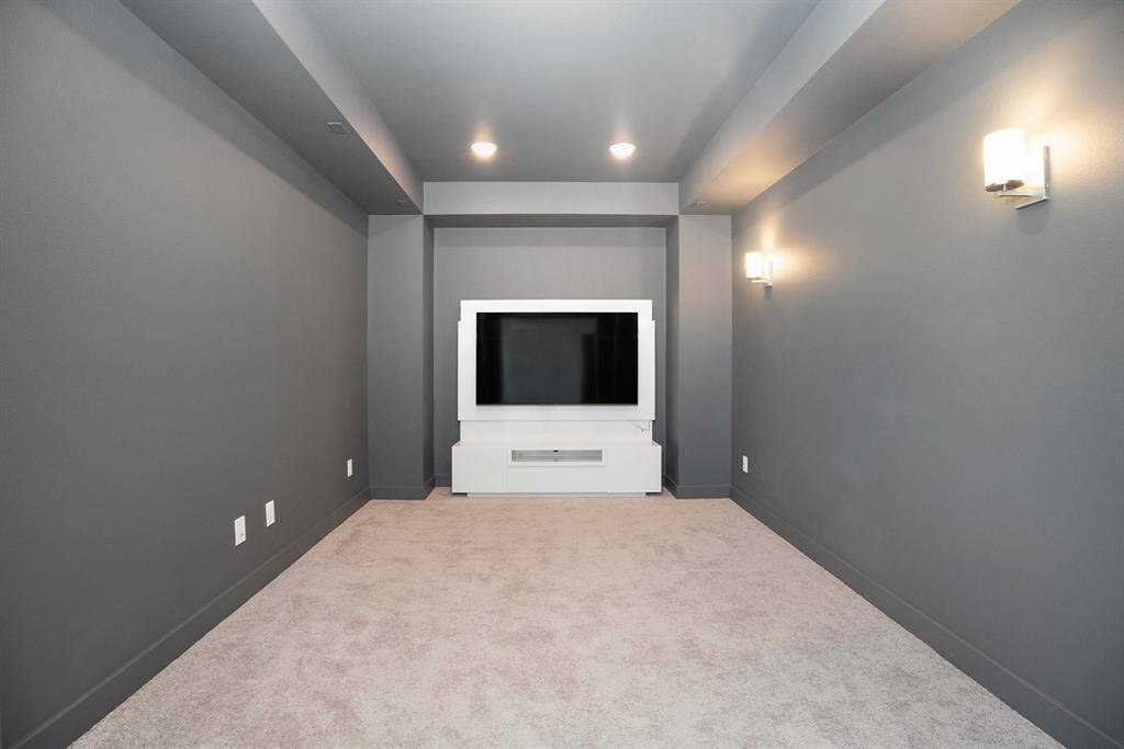 Media room offers darkness and privacy for movie nights.