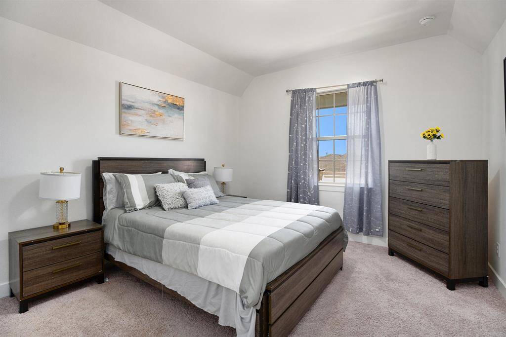 Second upstairs bedroom being used as a guest bedroom offers an en-suite bathroom.
