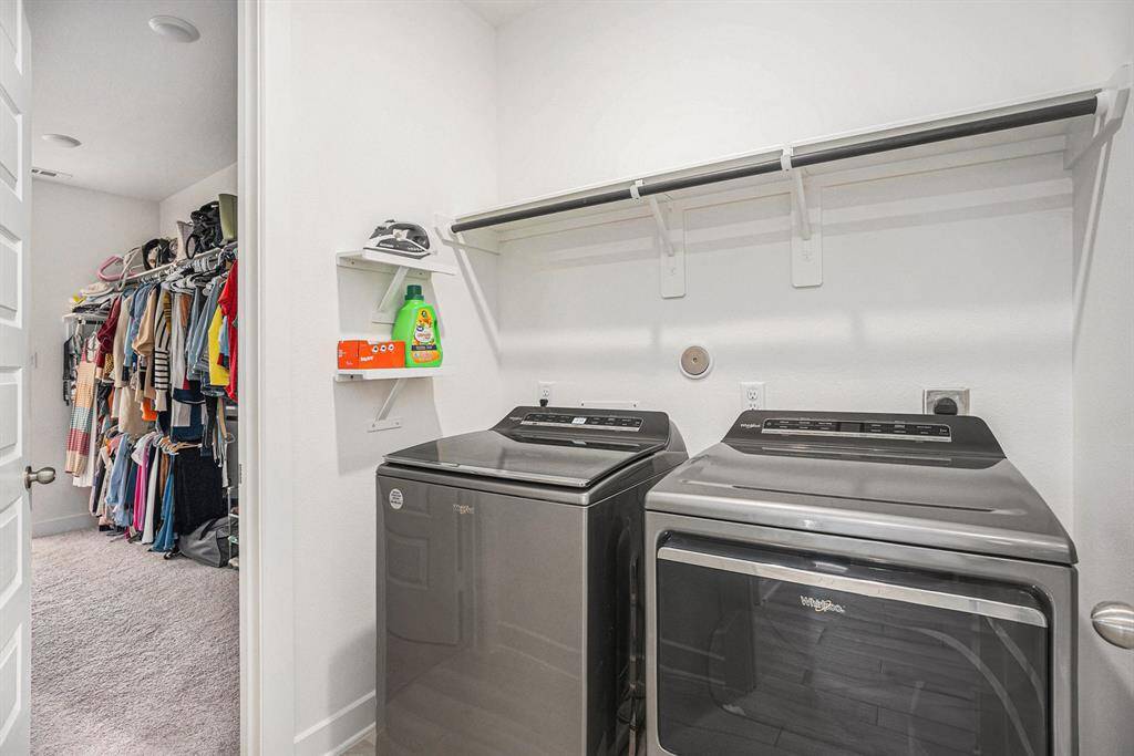 The utility room is strategically located off the primary closet.