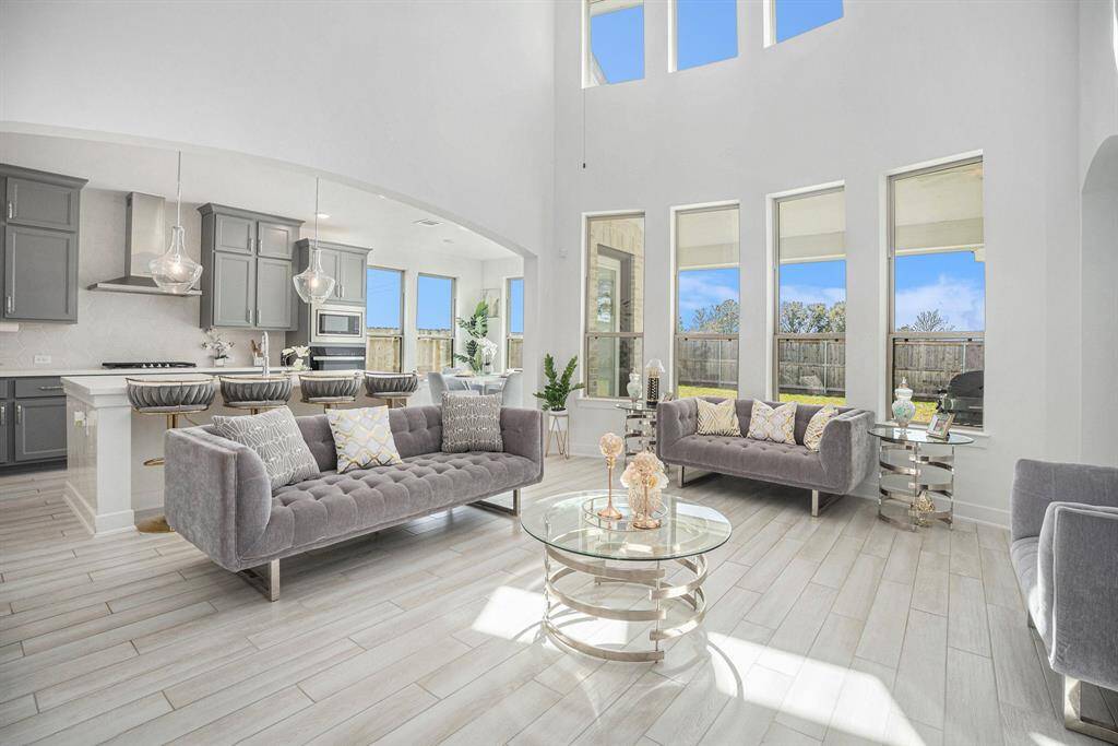 Floor to ceiling windows in the family room flood the space with natural light creating a bright and inviting atmosphere.