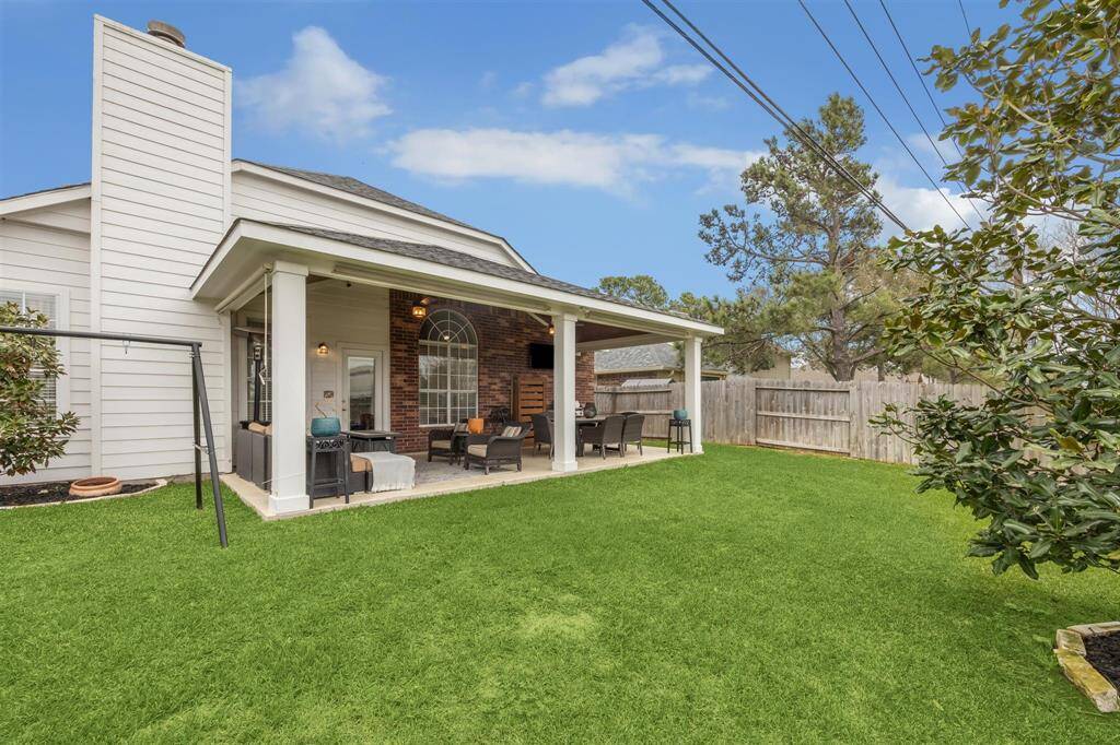 Backyard with plentiful grassy area for children and or pets.