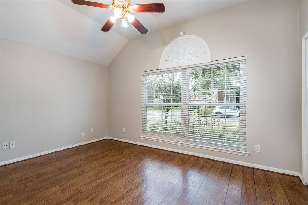 This third secondary bedroom boasts views of the front yard and cul-de-sac.
