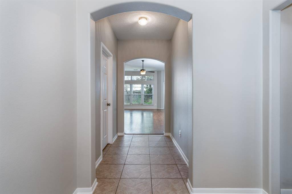 The foyer opens to secondary bedrooms to the right, laundry to the left and huge living room just beyond.