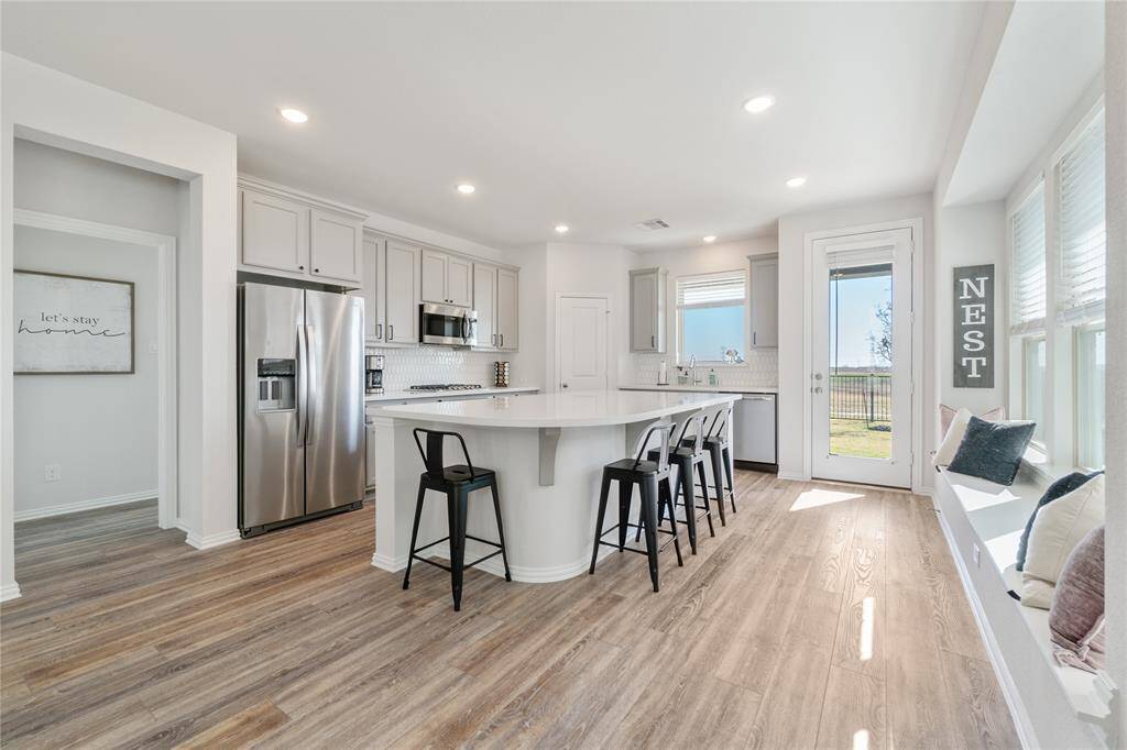 This bright, modern kitchen boasts sleek stainless steel appliances and a spacious island perfect for culinary adventures.