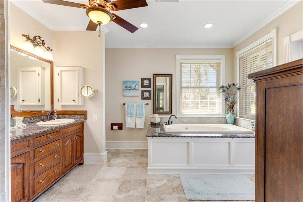 Primary Bathroom with his and hers sinks and a soaking tub.