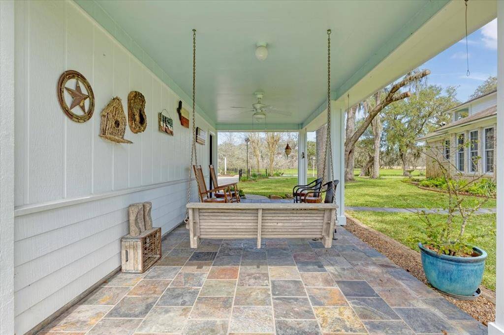 Secondary patio off of detached garage, patio swing excluded.