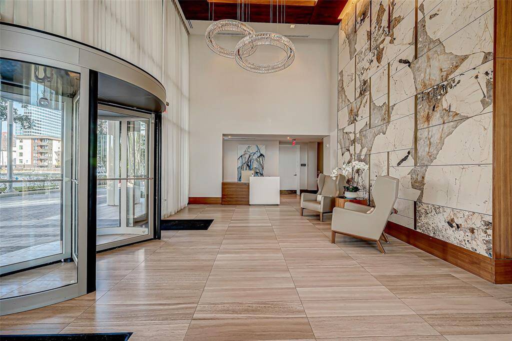 Welcome to elegance: A sunlit, spacious lobby with modern finishes and inviting seating area sets the tone for sophisticated living.