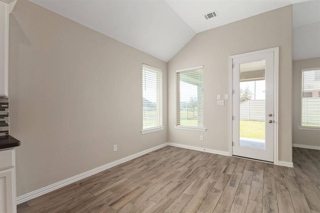 The breakfast area overlooks the covered back patio and lake!