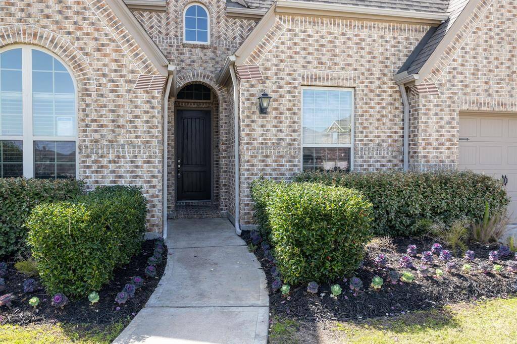 The front walkway leads past the updated landscaping to the covered front porch!