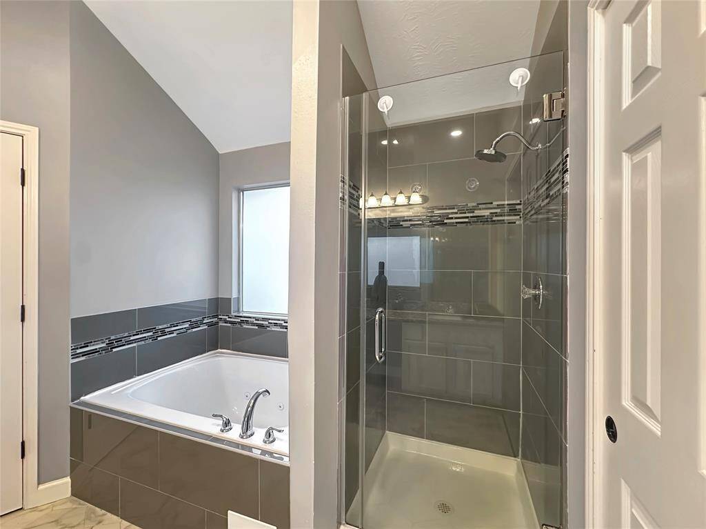 Beautiful walk in shower and spa tub.