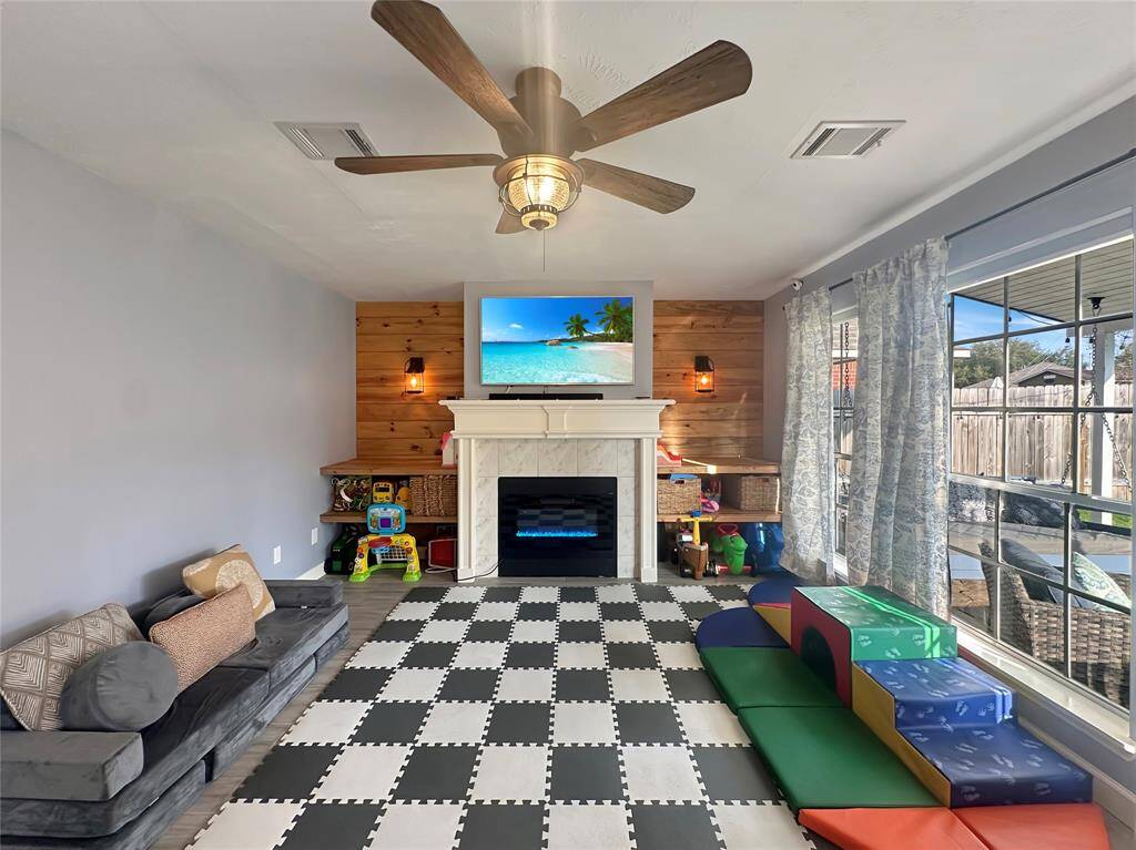 Spacious family room, currently staged as a fun play area, offering endless possibilities for relaxation or entertainment."