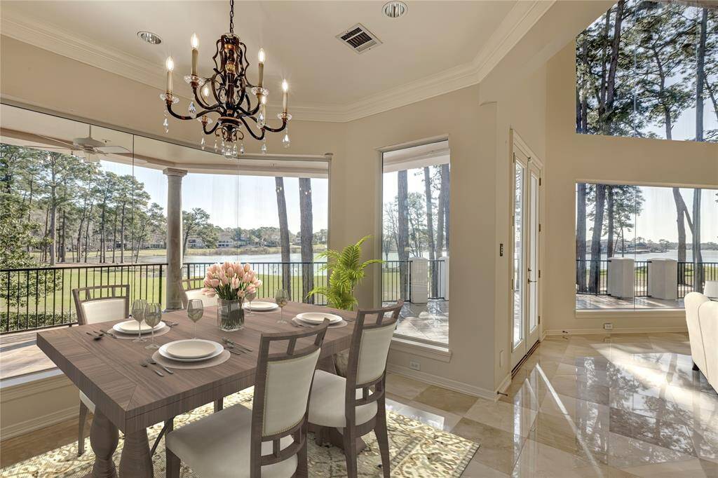 Imagine having your meals with these views of the Miller #5 hole and Lake Conroe.  Great outside porch area with outdoor kitchen.  Virtually staged.