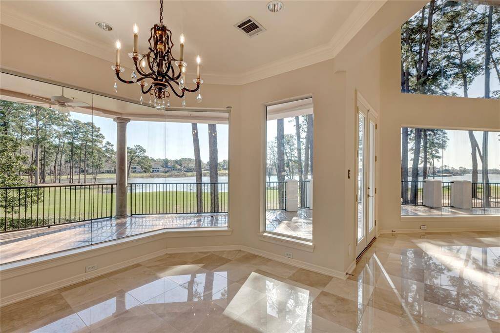 Outside covered porch with views of golf course and Lake Conroe.