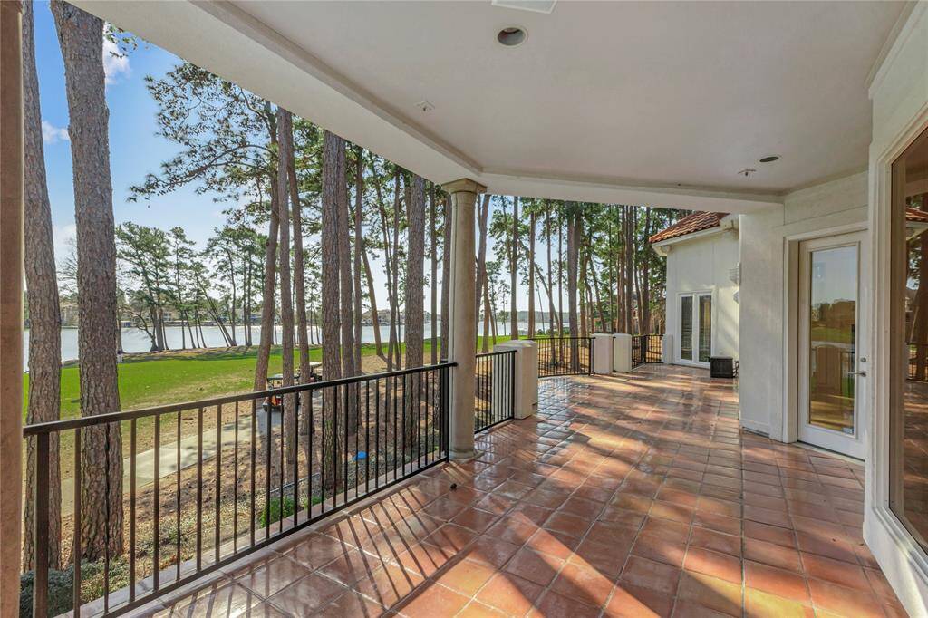 Outside covered porch with views of golf course and Lake Conroe.  Large area.