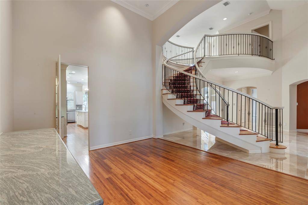 Dining room with views into the kitchen and the grand stairway.