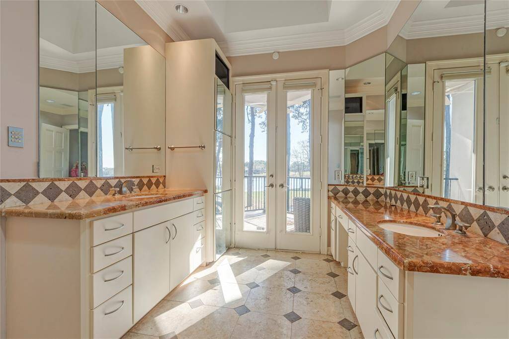 Primary bedroom with his and her sink area, your own refrigerator and porch to enjoy your morning coffee.