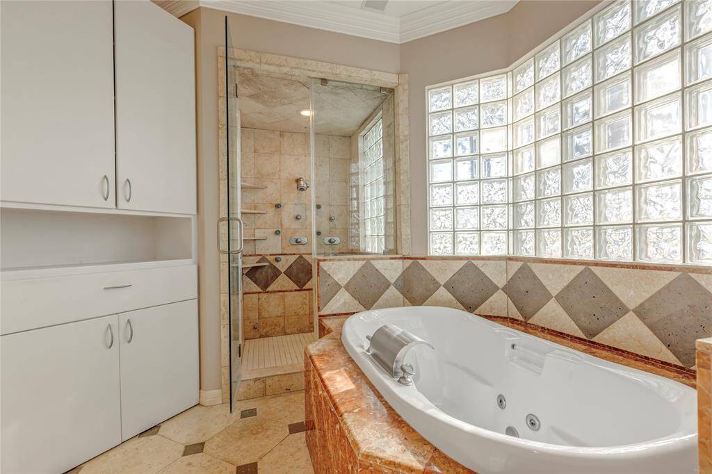 Primary bathroom with steam shower and jacuzzi tub.