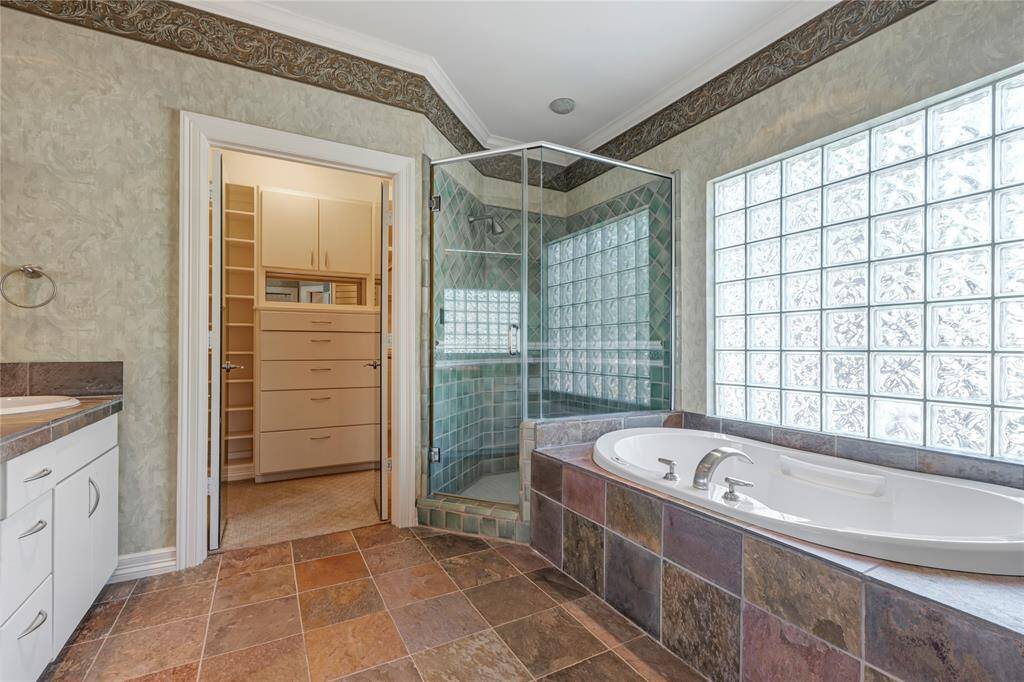 2nd primary bedroom bathroom with large spacious closet, own refrigerator, shower and tub.