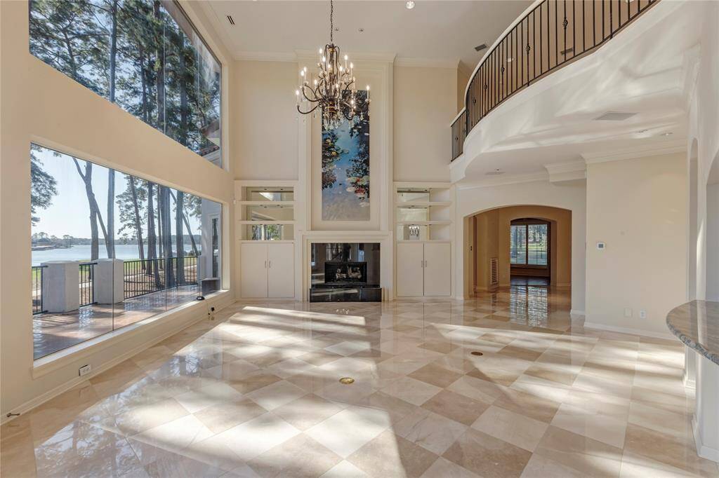 Views of Lake Conroe and golf course fairway and green.  The artwork above the fireplace was a commissioned piece for this area.  It is stunning.
