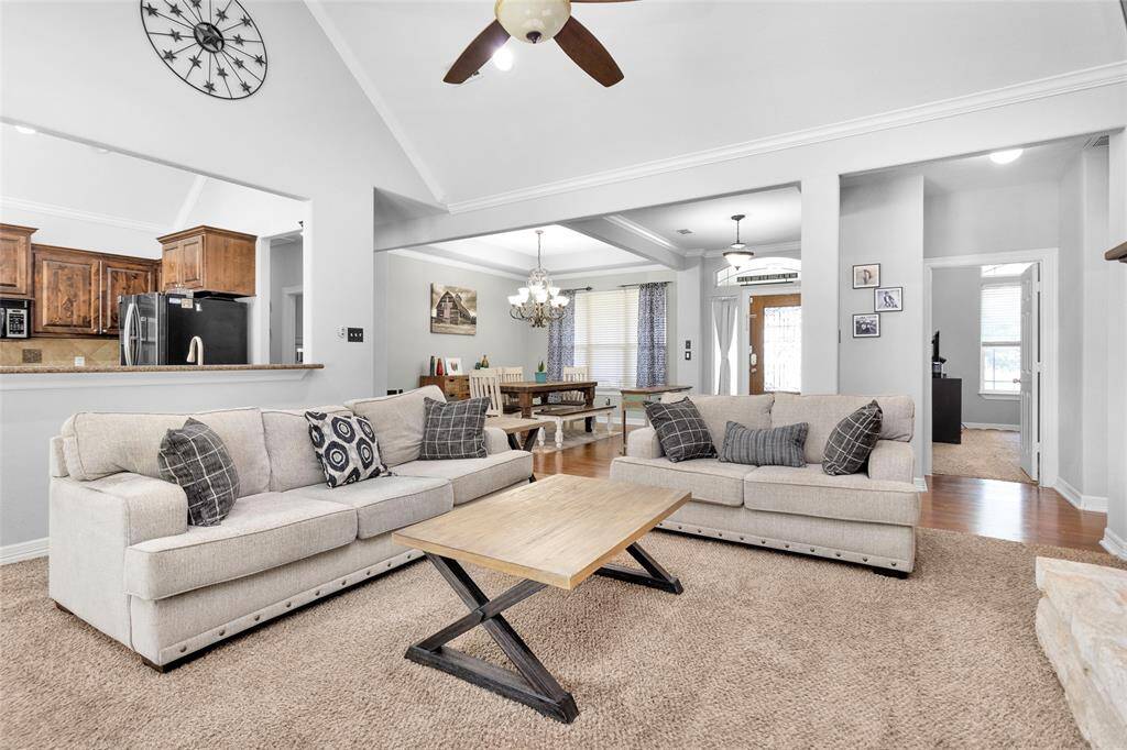 The split floor plan has the primary bedroom/bathroom and another bedroom (currently used as a study) and bathroom to the right of this picture. The laundry room and two secondary bedrooms and a bathroom to the left of the kitchen.
