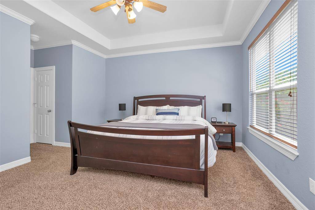 The 16x14 primary bedroom features tray ceiling, crown molding and separate closets.