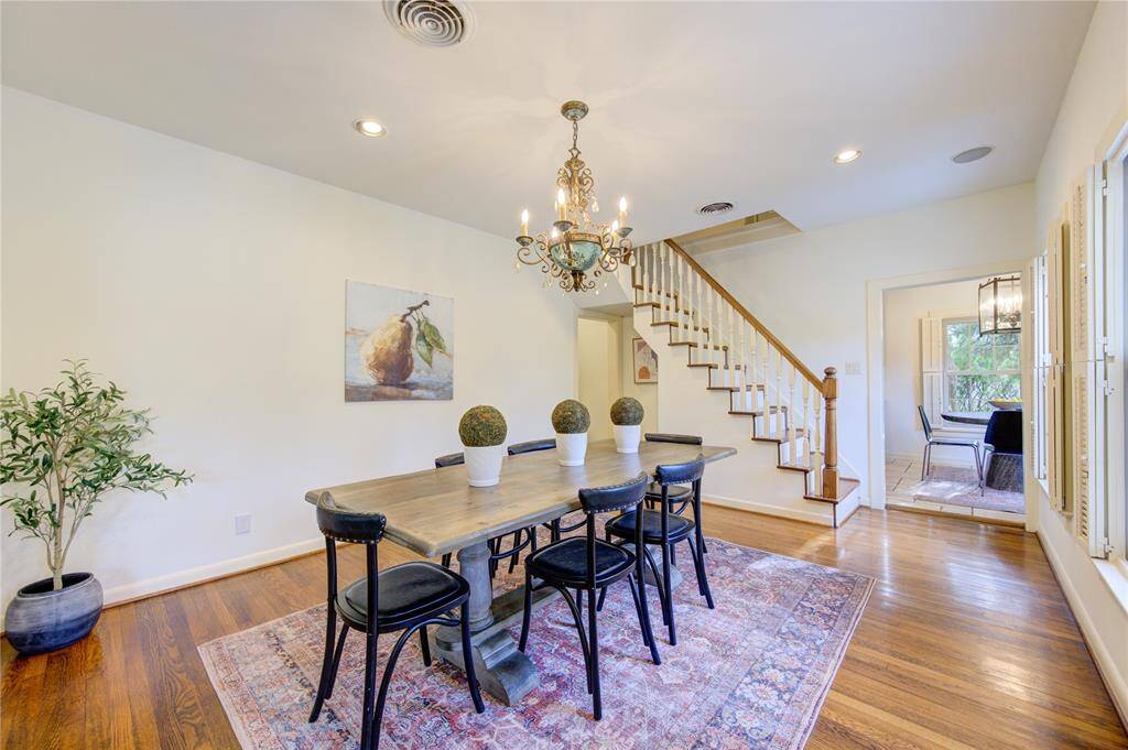 The spacious formal dining room is seamlessly open to the living room, creating a cohesive flow perfect for entertaining. With ample space for a large dining table, this area can comfortably host large parties and family gatherings.