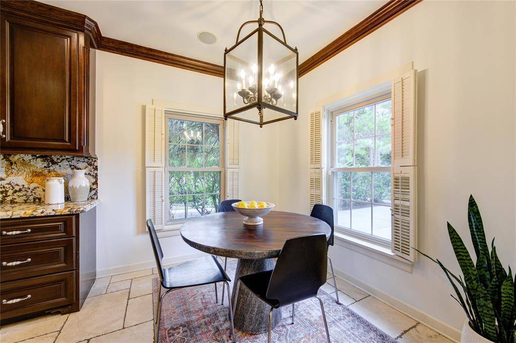 Located off the kitchen, the bright and airy breakfast room offers a cozy space for casual dining. Overlooking the front lawn through an abundance of windows, this room is bathed in natural light, creating a cheerful atmosphere for morning meals.