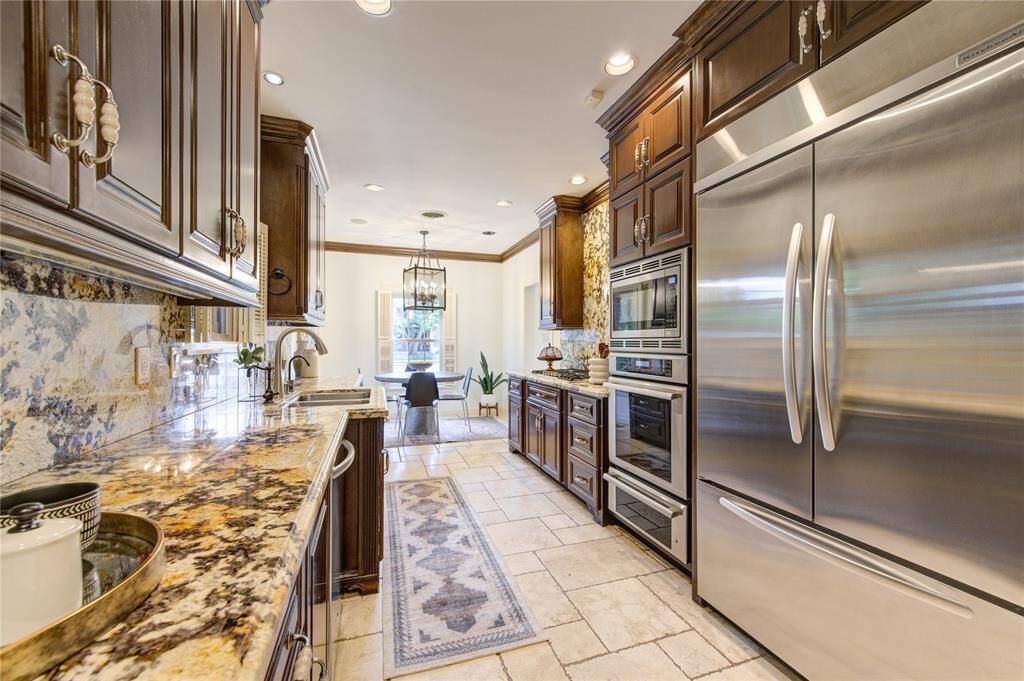 This gourmet kitchen, renovated in 2012, is a chef's dream come true. It boasts all new custom cabinets, stunning granite countertops, and top-of-the-line professional series KitchenAid appliances.