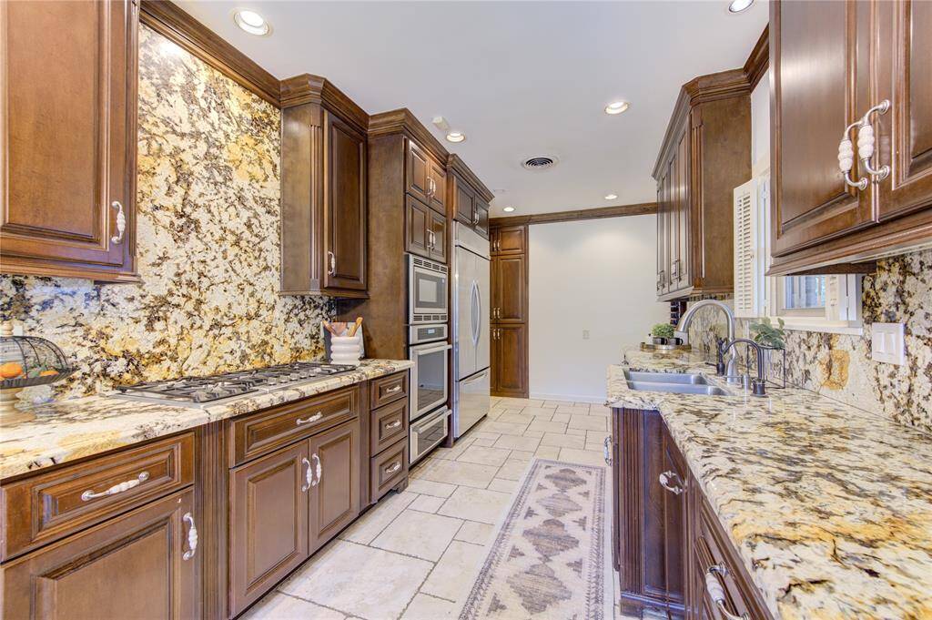 Modern amenities such as a double oven, built-in microwave, and a sleek cooktop ensure that every culinary need is met. The stylish yet functional layout makes this kitchen perfect for both everyday cooking and entertaining.