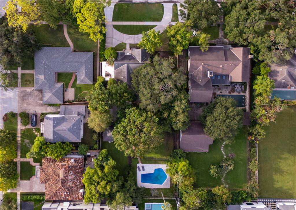 Aerial view capturing the full extent of the over 22,000 sq ft lot. This shot emphasizes the vast space surrounding the home, including the lush side yards and expansive backyard, providing a comprehensive view of the property's grandeur and potential.