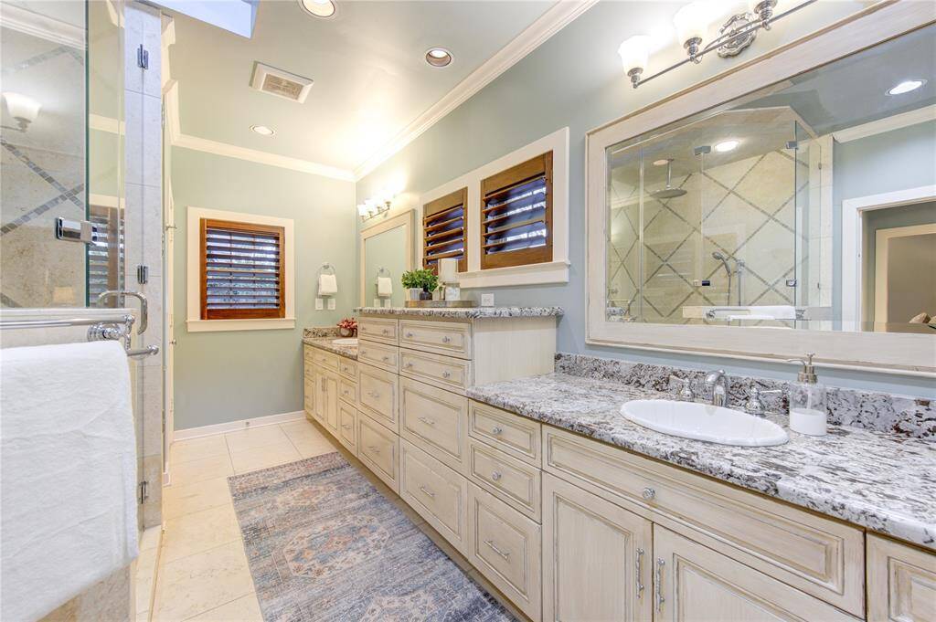 The en-suite primary bathroom, completely renovated in 2012, is designed for today's modern lifestyle. It features a double sink vanity with elegant granite counters, providing ample space for personal care.