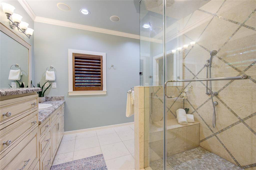 Luxurious walk-in shower with a frameless shower door adds a sleek, contemporary touch. High-quality fixtures and finishes throughout ensure a spa-like experience in the comfort of your own home.