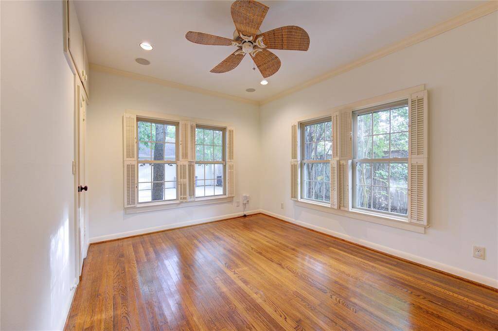 Another generously sized secondary bedroom, offering the same high-quality finishes with hardwood floors, recessed lighting, and a ceiling fan. The room's large windows and ample closet space make it both functional and comfortable.
