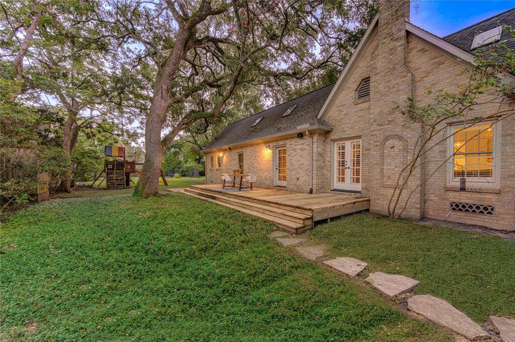 Spacious side yard with lush green grass and well-maintained landscaping, offering additional outdoor space for activities and potential future expansions.