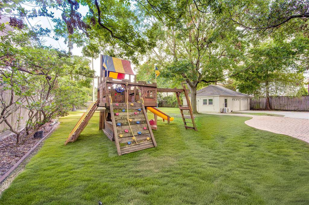 Designated play area with a well-kept lawn and safe space for children to play, offering a family-friendly environment.