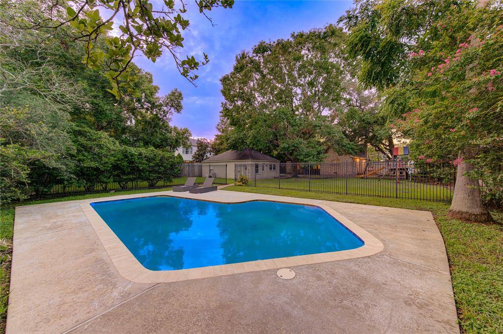 Close-up of the sparkling pool surrounded by a spacious deck area with plenty of room for lounging and sunbathing. The pool area is ideal for summer gatherings and outdoor fun. Sequestered in the back half of the yard with a fence that offers security for small children.