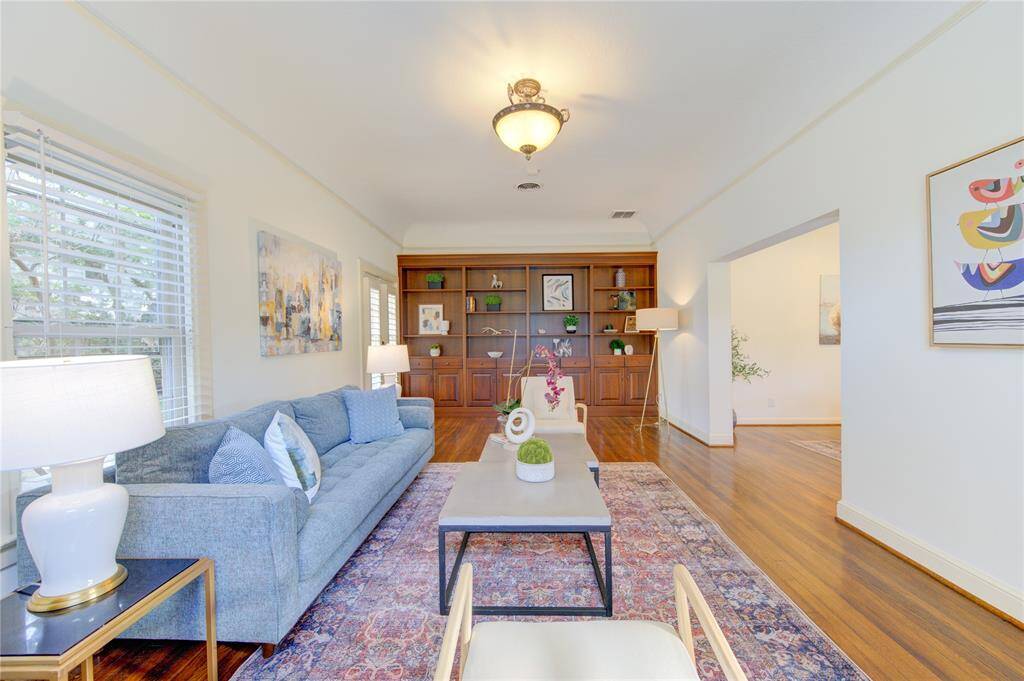 tep into the bright and inviting living room, where elegance meets functionality. This expansive space features beautiful hardwood floors that run throughout, adding warmth and sophistication. The high ceilings enhance the room's airy feel, creating an open and spacious atmosphere.